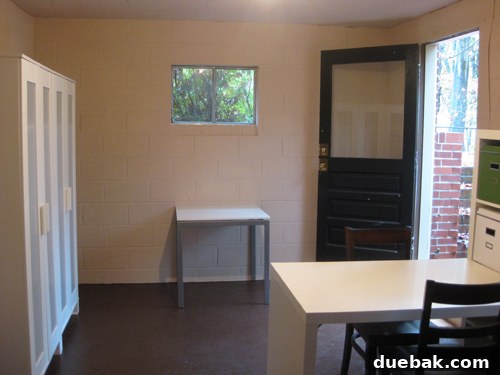 The white table, relocated to the basement, repurposed within the ongoing basement renovation project.