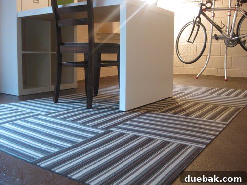 Finished section of Flor Ascot Stripe modular carpet tiles, showing the seamless and secure end result of the installation.