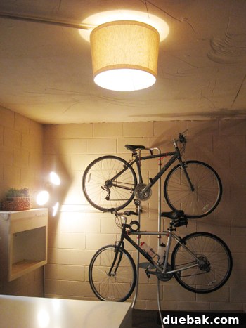 DIY ceiling light upgrade, showing a polished linen lampshade attached directly to a bare bulb fixture, transforming the lighting.