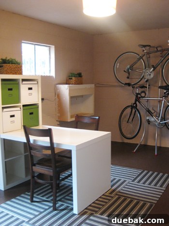 Overview of the updated basement, showing the new rug, light fixture, bike rack, and potential areas for future renovation projects.