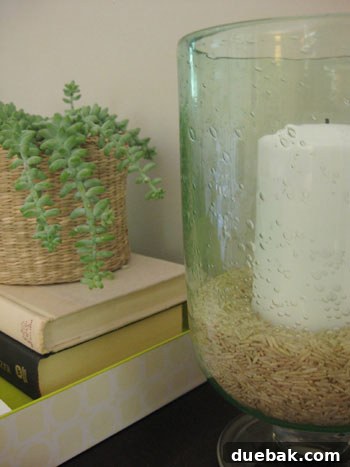 Console table adorned with natural materials, showcasing a variety of woven baskets in different sizes and a vase creatively filled with brown rice, demonstrating unique and rustic fall decor ideas.