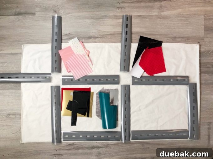 Build Your Own Adventure Car Play Mat with Cricut Maker 5 Creative arrangement of car play mat components on a large fabric base, ready for ironing.