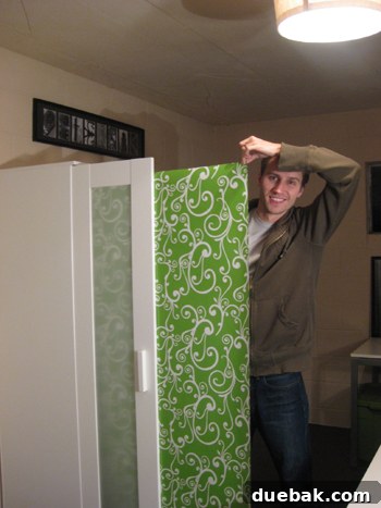 Dress Up Your Glass Doors with Gift Wrap 11 Detailed shot of green and white wrapping paper being applied inside armoire door