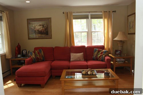 Abbey's family room before renovation, showcasing lighter walls and existing furniture layout.