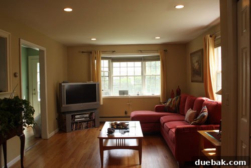 Another view of the family room before, highlighting the need for defined zones and added warmth.