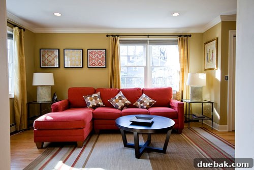 Abbey's family room after the makeover, featuring deeper wall color, new rug, and updated furnishings.