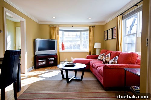 Another view of the transformed family room, highlighting the added workstation and sophisticated decor.