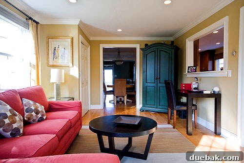 Close-up of the family room after, showcasing the new lamps, geometric pillows, and curated art.