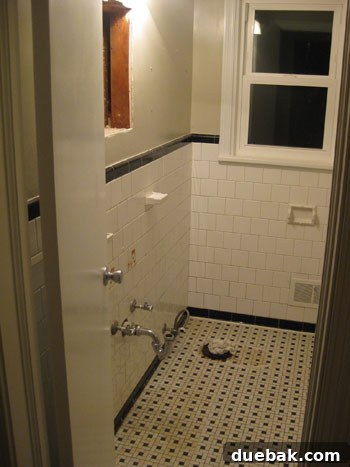 A rag is stuffed into the toilet's sewage opening to block fumes and debris during demolition.