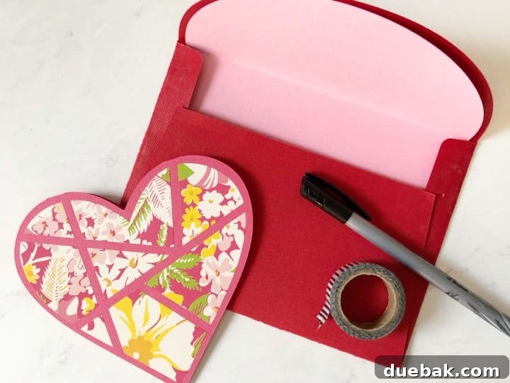 A festive Valentine's Day heart card adorned with patterned iron-on vinyl on cardstock.