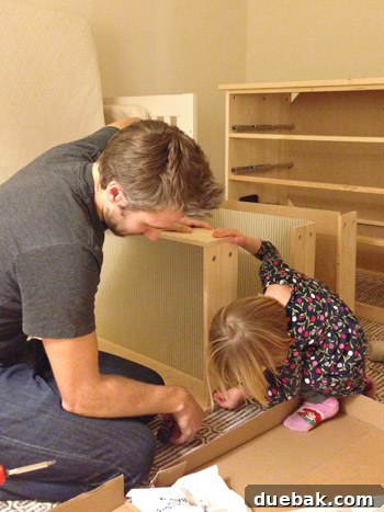 A child helping assemble nursery furniture for their baby brother
