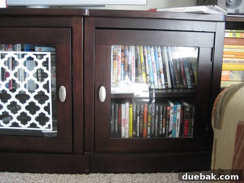 Before DIY entertainment center makeover with clear glass doors and stenciled pattern awaiting spray