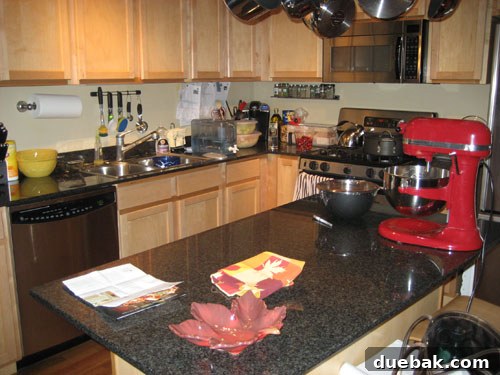 Effortless Elegance: $100 DIY Stainless Stick-On Backsplash 2 Before image of a kitchen backsplash, showing an outdated or plain design that will be updated with stainless steel tiles.