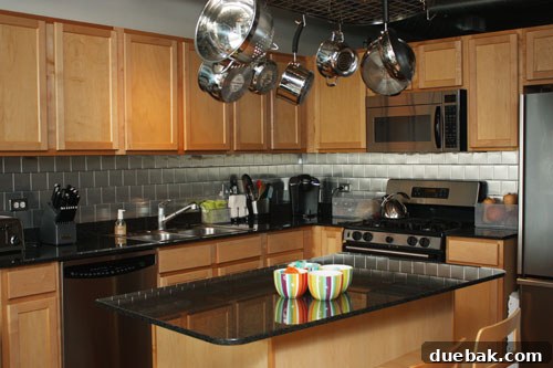 Effortless Elegance: $100 DIY Stainless Stick-On Backsplash 3 After image of the kitchen backsplash, now covered with sleek stainless steel tiles, showing a modern and clean aesthetic.