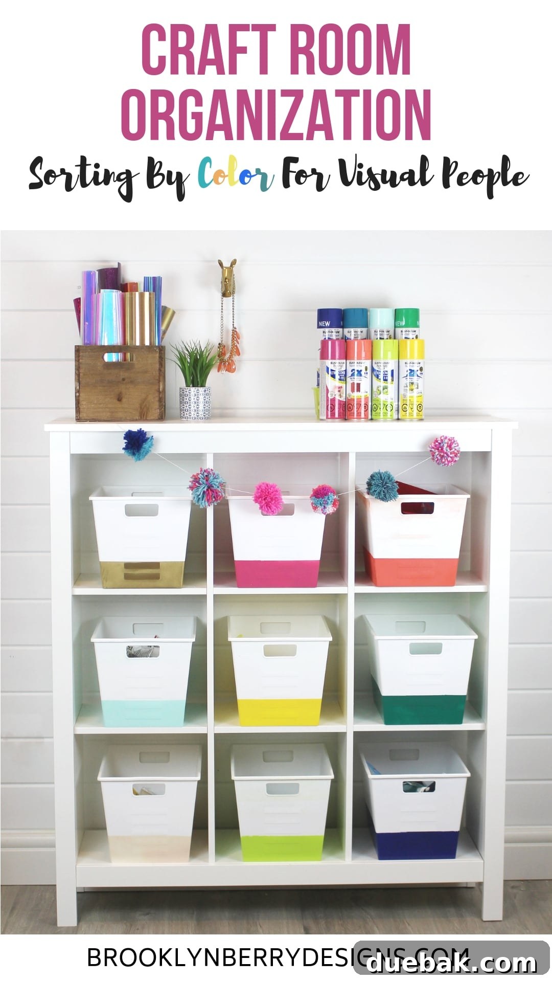 Organized craft room with supplies sorted by color, featuring white bins with color-blocked bottoms.