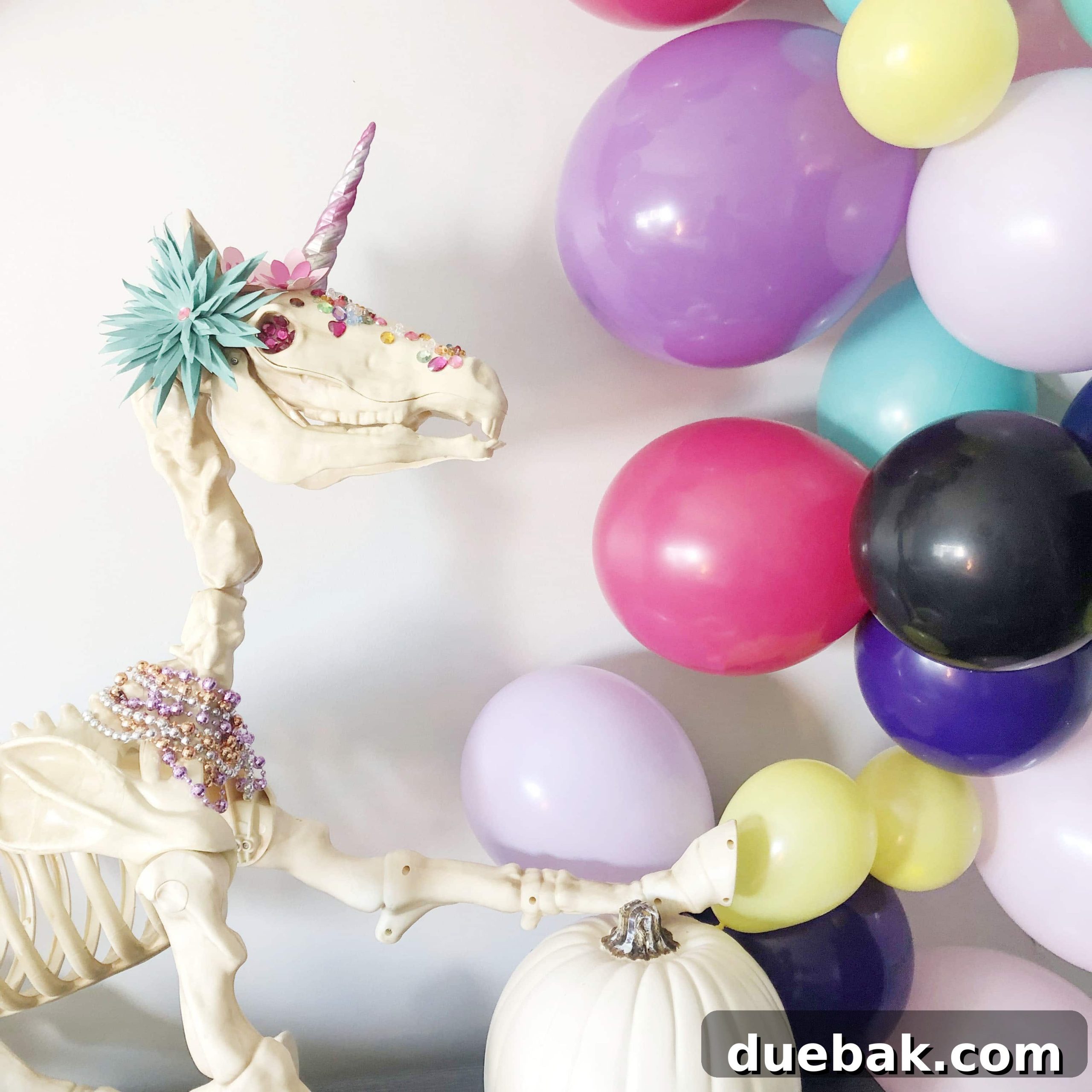 The Spectral Unicorn Soiree 3 Close-up of a unicorn skeleton's head decorated with paper flowers and jewels for Halloween