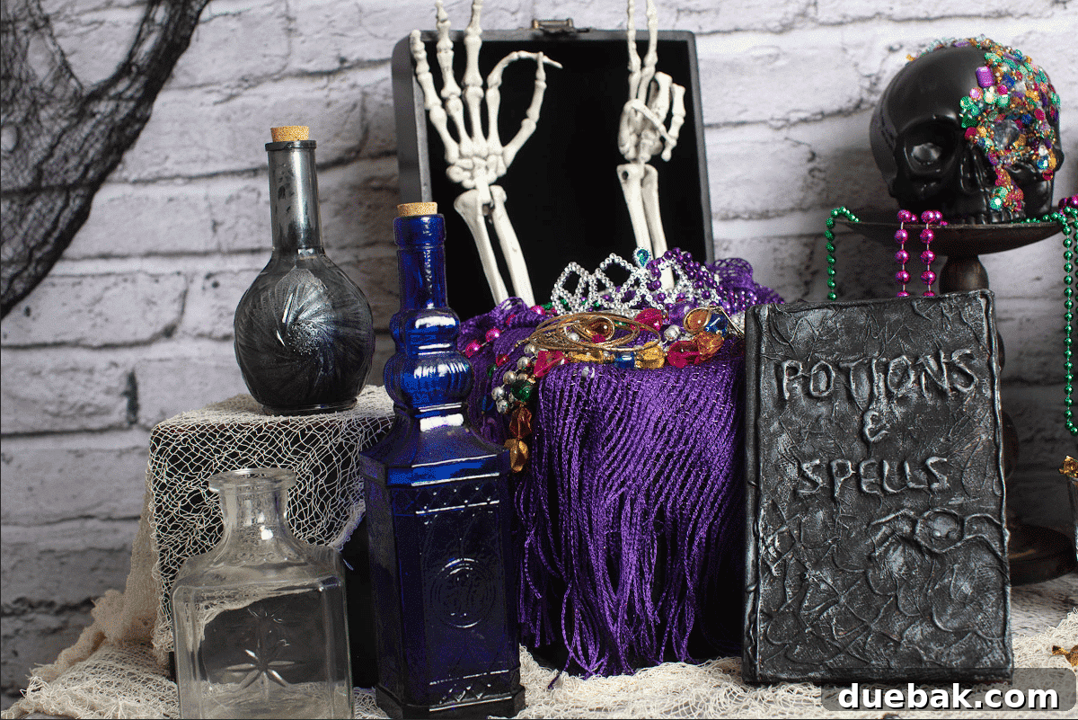 The Spectral Unicorn Soiree 7 Gold skeleton sitting on a table with a DIY 'treasure chest' filled with colorful jewels