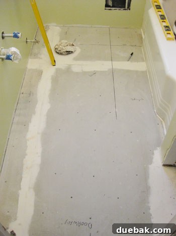 Guidelines drawn on backerboard for precise marble floor tile layout