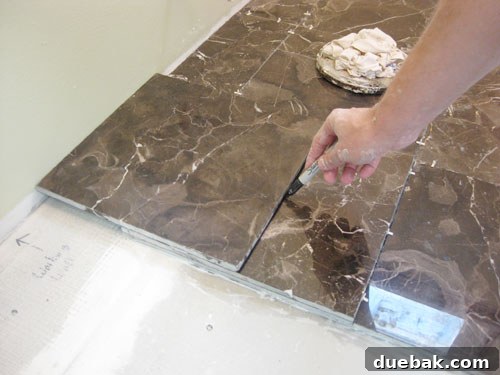 Measuring tile cuts against a wall using a stack of tiles