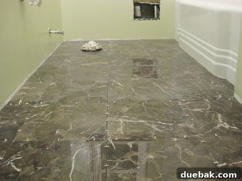 Finished marble floor tile installation in a bathroom