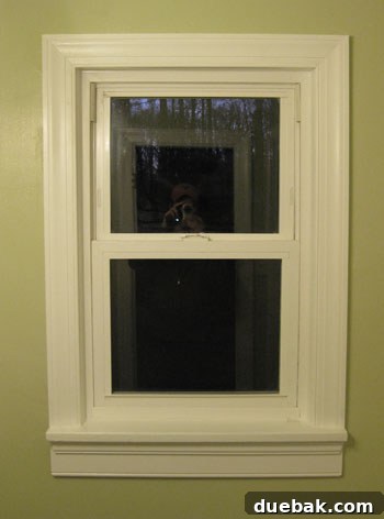 Elevate Your Bathroom Renovation with Flawless Baseboard and Trim Installation 13 The finished window trim after caulking and painting, looking clean and polished.