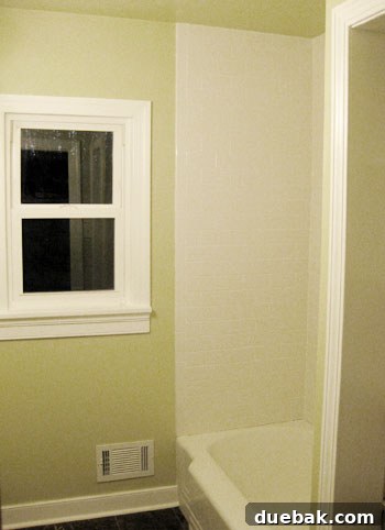Elevate Your Bathroom Renovation with Flawless Baseboard and Trim Installation 19 Close-up view of the perfectly installed baseboard and quarter-round, freshly painted.