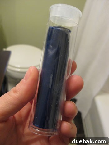 Close up of a pipe joint sealed with blue Loctite putty