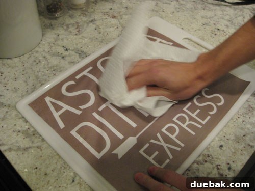 Crafting Vintage Wood and Paper Wall Signs 8 Paper towel being rubbed over a damp print for distressing