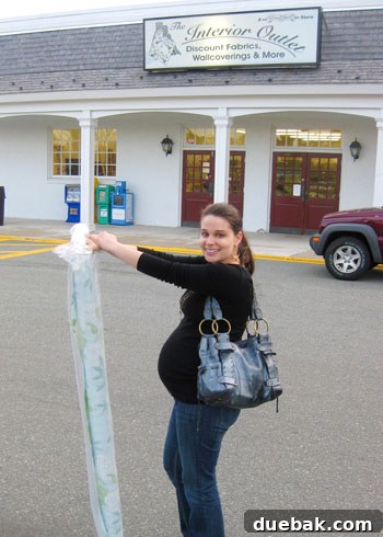 Choosing Nursery Rugs and Curtain Fabric 6 Pregnant woman showing off fabric and baby bump