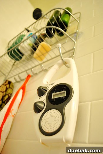 A sleek, waterproof shower radio mounted in a modern bathroom, playing calming music during a morning shower ritual.