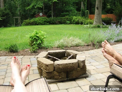 A cozy backyard firepit glowing warmly under the evening sky, perfect for making s'mores and extending weekend relaxation with friends and family.