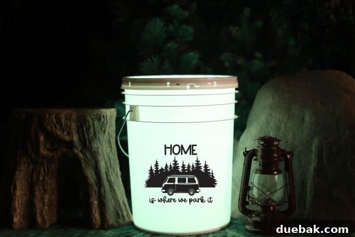 Close-up of a DIY camping bucket light, featuring the 'Home Is Where You Park It' SVG design with a vintage camping van. The intricate detail of the vinyl application is visible, highlighting the quality of the personalized craft.