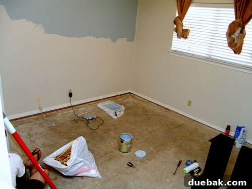 Guest room before nursery makeover, featuring a plain room with beige carpet and simple furniture.