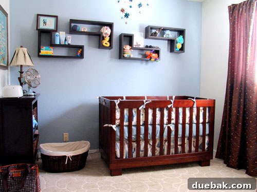 Charming blue nursery after makeover, showing a crib, dresser, and wall decor.