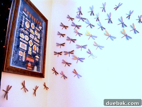 Nursery view showing a recliner, rug, and wall art including Umbra dragonflies.