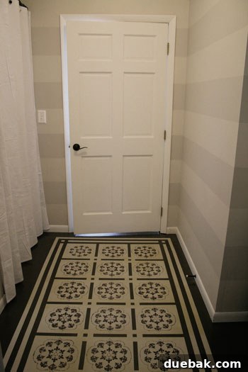 Subtle Stripes, Stenciled Style: Revamping Your Bathroom 4 After Roeshel's stunning bathroom makeover, featuring painted stenciled floors and elegant striped walls.
