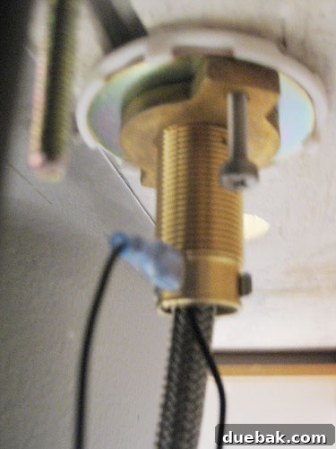 Attaching metal clip under spout