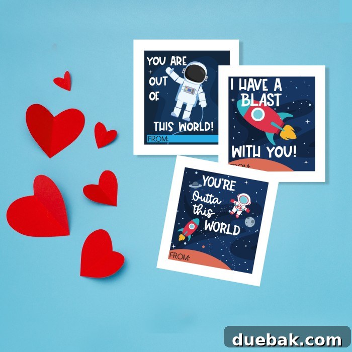 Close-up of cut out paper hearts and paper featuring various space-themed valentine cards with rocket ships, planets, and astronauts.