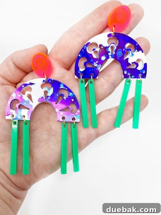 Vibrant rainbow-colored acrylic earrings made with a Glowforge, highlighting diverse material options.