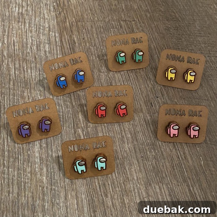 Playful Among Us themed earrings crafted from various materials using a Glowforge, displaying detailed engraving.