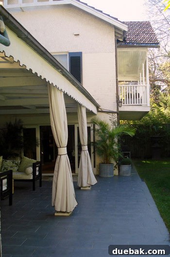 Sydney Architectural Marvel: A Home Unveiled 14 View of the outdoor living space with custom awning and clean-lined pavers