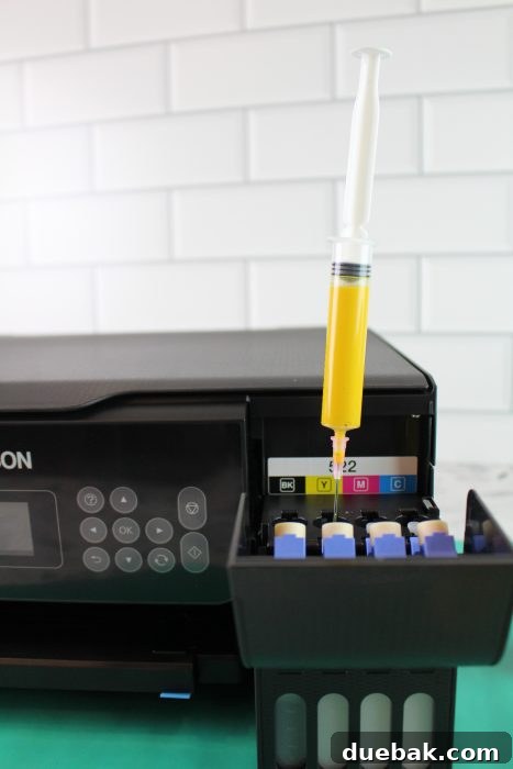 Unlock Sublimation Printing with Your EcoTank 13 Demonstration of tipping an ink bottle at an angle to draw ink with a syringe.