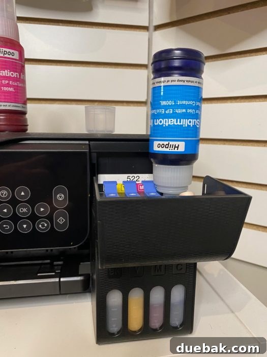Unlock Sublimation Printing with Your EcoTank 8 Epson EcoTank printer ink tanks being filled with sublimation ink using the direct-fill method.