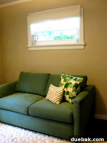 Sleeper sofa placed under the window, showing increased floor space.