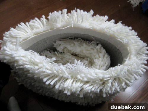 A rectangular piece of leftover shag rug being prepared to be made into a pillow.