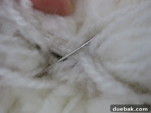 A very close-up shot showing how deeply the safety pins are buried in the shag fabric, making them invisible and safe.