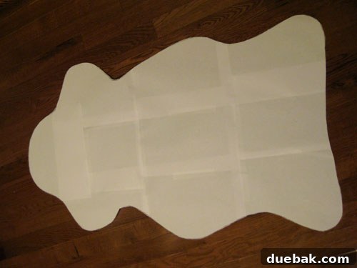 The sheepskin template being cut out from the taped-together paper.