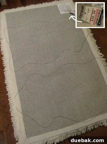 The paper sheepskin template placed on the back of the shag rug, with the outline traced by a marker.