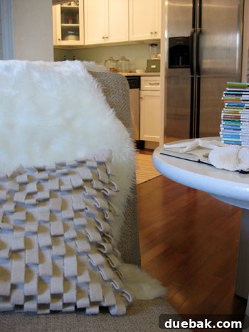 Close-up view of the faux sheepskin throw on the slipper chair, emphasizing its plush softness and texture.