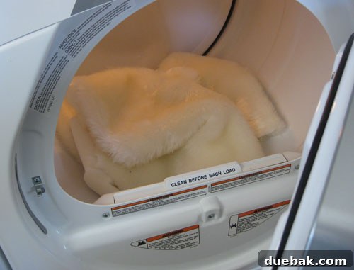 Faux Sheepskin Rug: The Finishing Touches 6 Three newly cut faux sheepskin throws in a dryer, showing their fluffy texture.